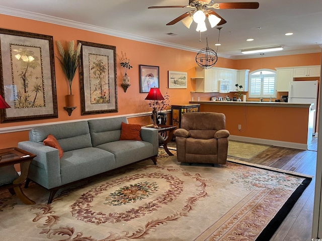 living room featuring ceiling fan, crown molding, and light wood-type flooring