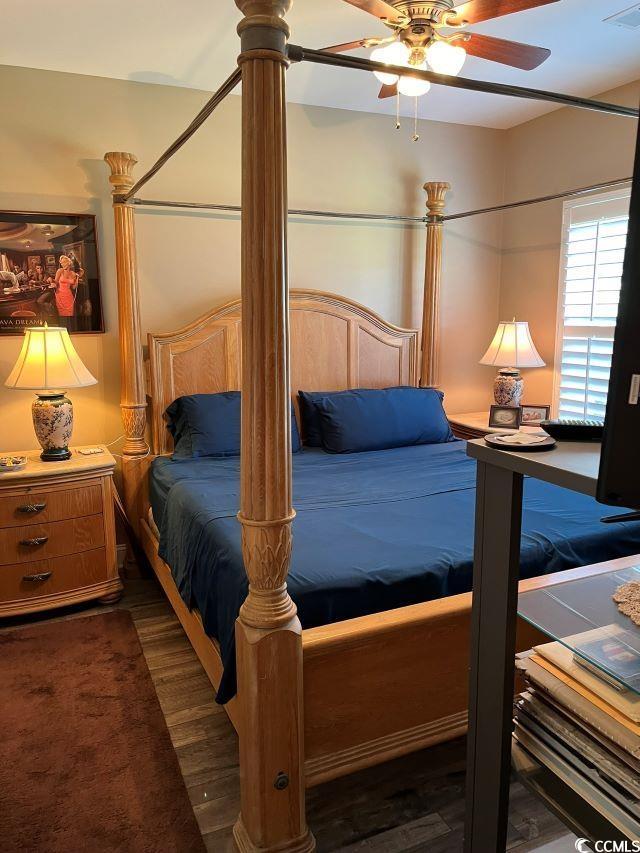 bedroom featuring ceiling fan and dark wood-type flooring