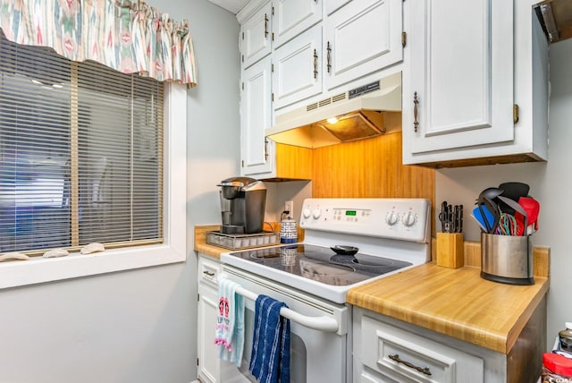 kitchen featuring white cabinetry and white range with electric cooktop