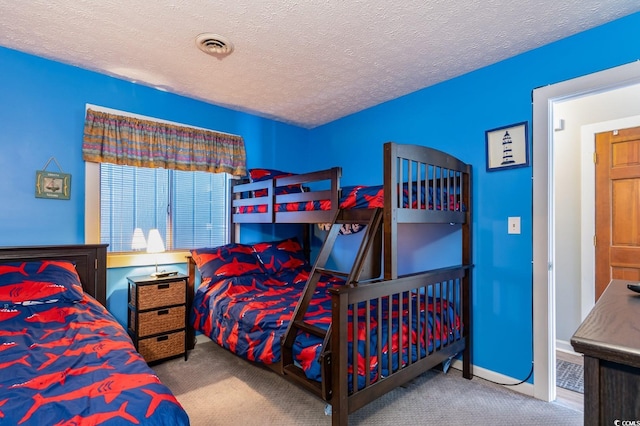 bedroom featuring a textured ceiling and carpet flooring