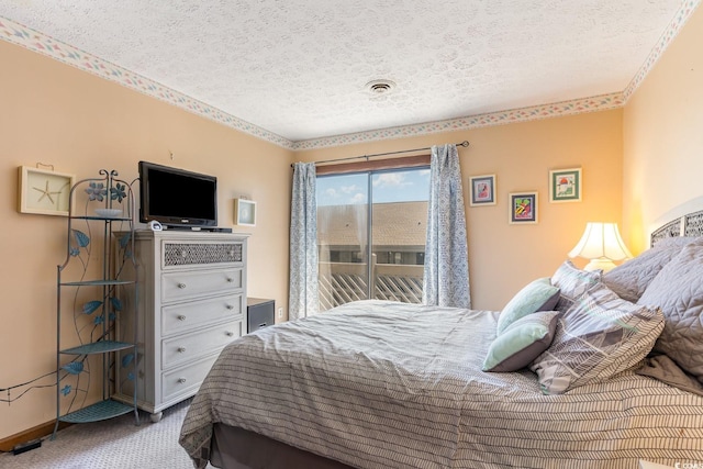 carpeted bedroom featuring a textured ceiling