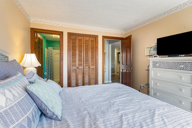 bedroom featuring a closet, wood-type flooring, and a textured ceiling