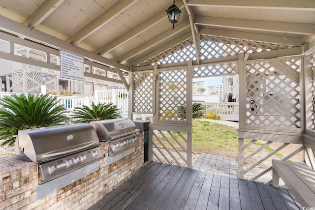 wooden terrace with exterior kitchen and grilling area