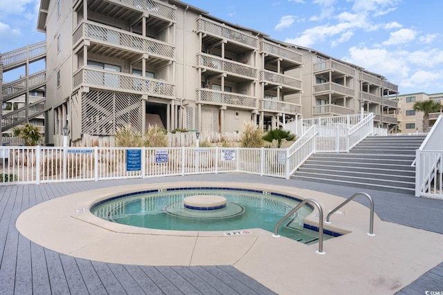 view of swimming pool featuring a hot tub