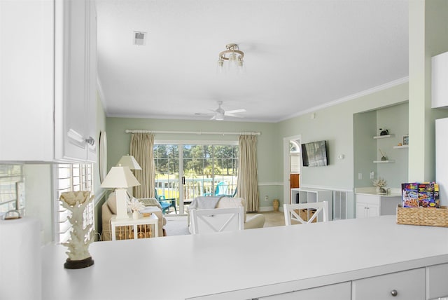 dining room featuring ornamental molding, ceiling fan, and built in features