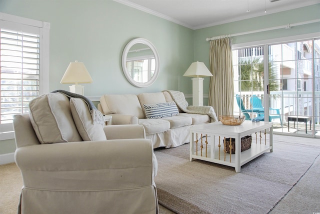 living room featuring a healthy amount of sunlight, carpet, and crown molding