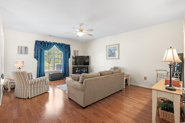 living room with ceiling fan and hardwood / wood-style flooring