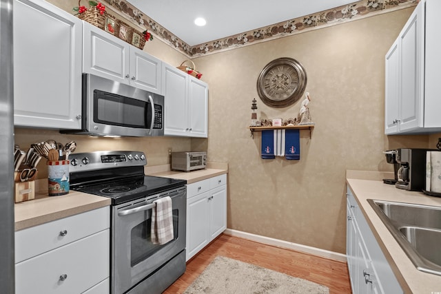 kitchen with stainless steel appliances and white cabinetry