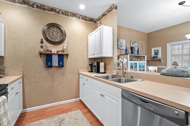 kitchen featuring sink, light hardwood / wood-style flooring, white cabinetry, and stainless steel dishwasher