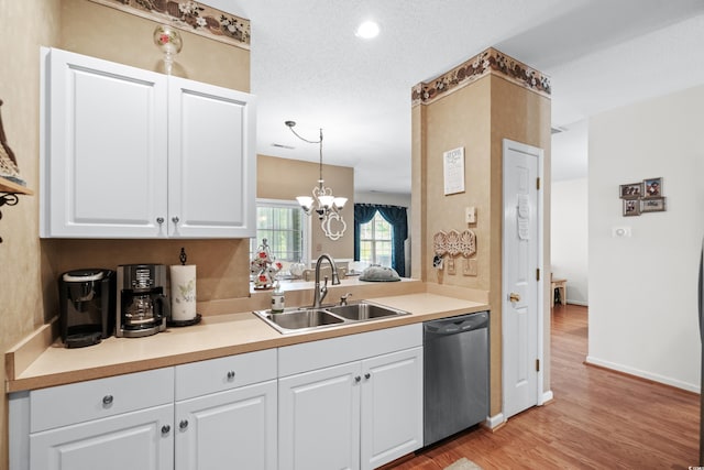 kitchen with decorative light fixtures, light hardwood / wood-style flooring, white cabinetry, sink, and stainless steel dishwasher