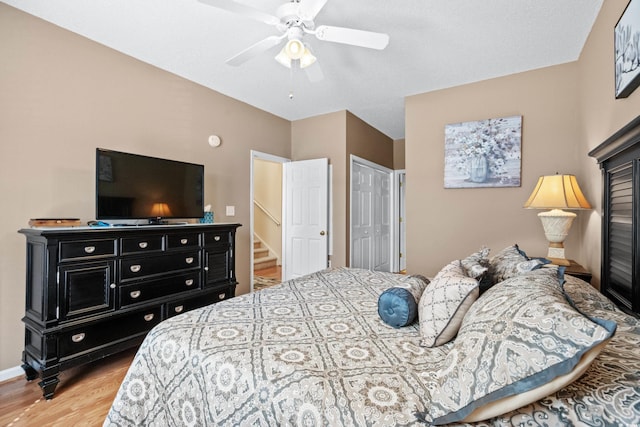 bedroom with a closet, ceiling fan, and light wood-type flooring