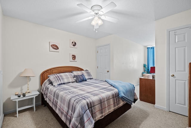 bedroom with carpet, ceiling fan, and a textured ceiling