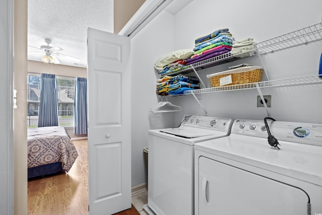 washroom featuring washer and dryer, ceiling fan, a textured ceiling, and light wood-type flooring