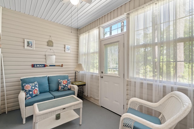 sunroom / solarium with a healthy amount of sunlight and ceiling fan