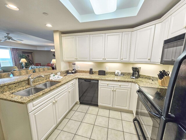 kitchen featuring black appliances, kitchen peninsula, light tile floors, sink, and ceiling fan