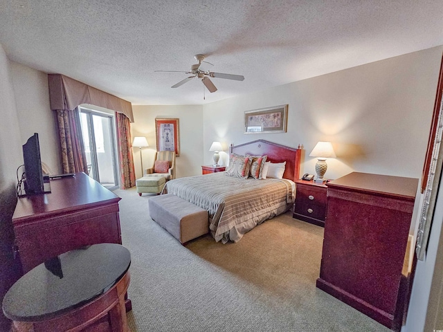 bedroom with carpet, ceiling fan, and a textured ceiling