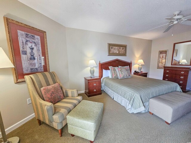 bedroom featuring a textured ceiling, ceiling fan, and carpet flooring