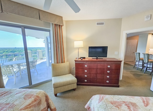 bedroom featuring carpet, ceiling fan, access to outside, and a textured ceiling