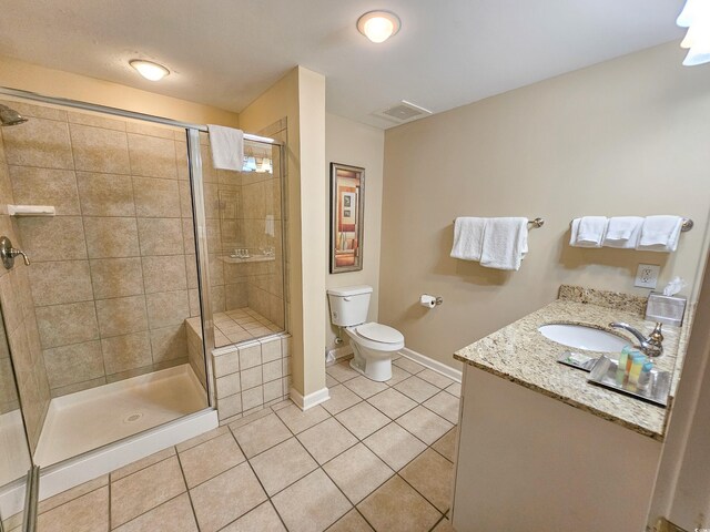 bathroom with an enclosed shower, vanity, toilet, and tile flooring