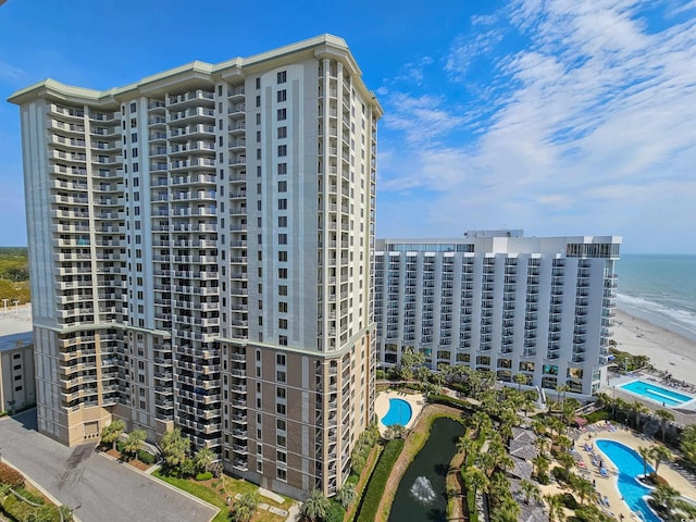 view of property featuring a water view and a community pool