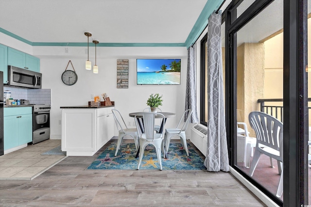 dining space with light hardwood / wood-style flooring and crown molding