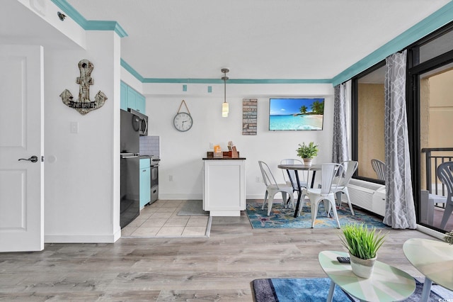 dining area with ornamental molding and light tile flooring