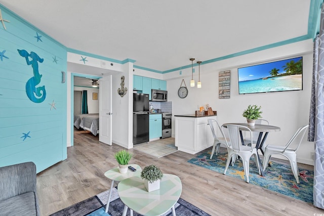 dining area with ceiling fan and light wood-type flooring