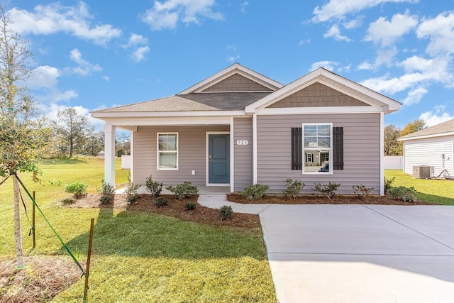 view of front of house featuring central AC and a front lawn