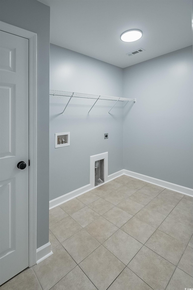 clothes washing area with washer hookup, electric dryer hookup, and light tile floors