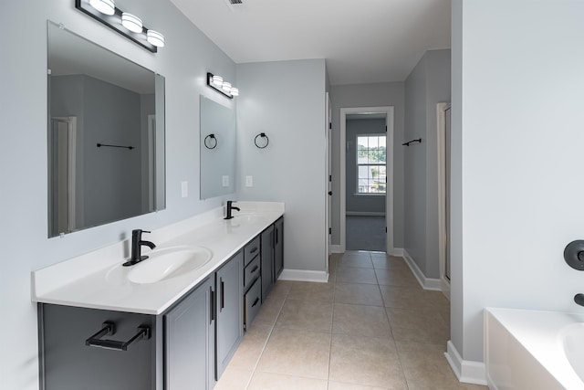 bathroom featuring plus walk in shower, dual bowl vanity, and tile flooring