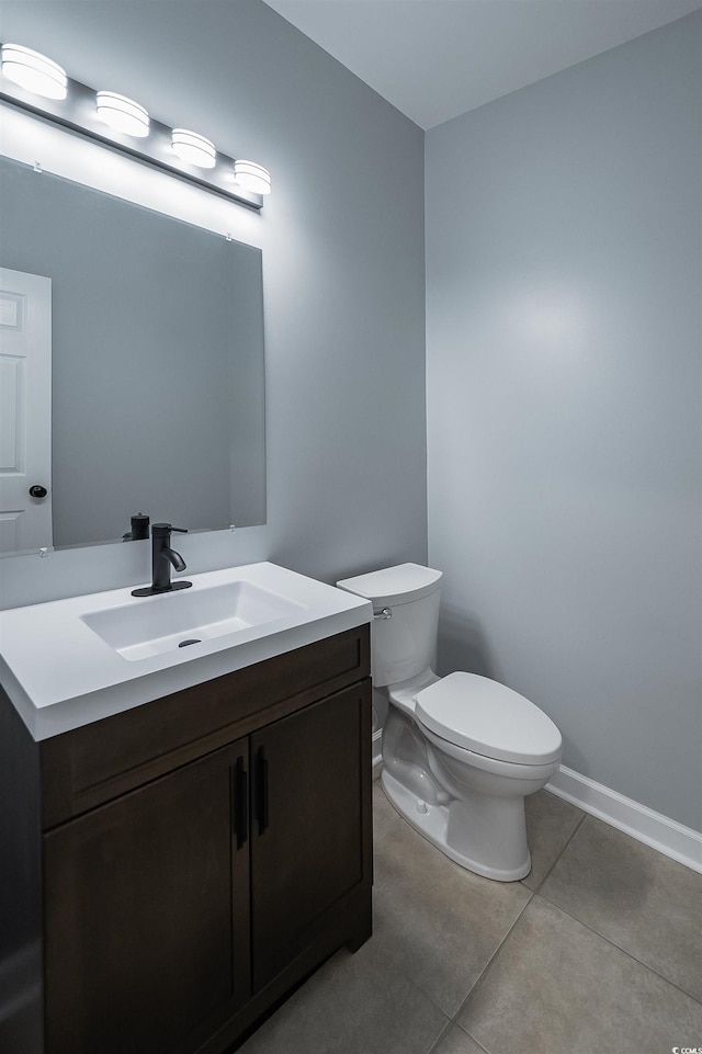 bathroom featuring vanity, tile floors, and toilet