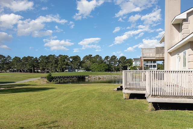 view of yard with a water view and a balcony