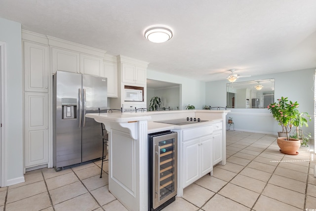 kitchen featuring ceiling fan, a breakfast bar, wine cooler, light tile flooring, and stainless steel fridge