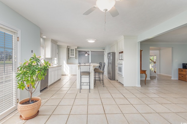 tiled dining room with ceiling fan