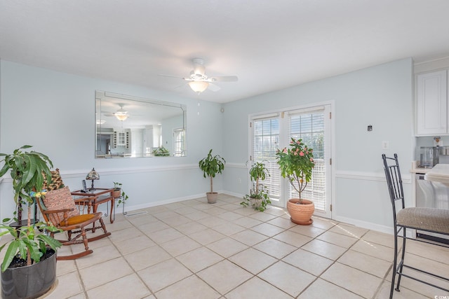 living area with ceiling fan and light tile floors