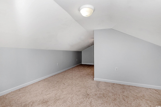 bonus room featuring lofted ceiling and carpet flooring