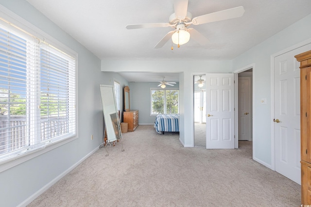 unfurnished bedroom featuring ceiling fan and light carpet