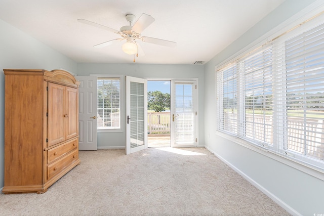 interior space featuring ceiling fan, light carpet, and access to outside