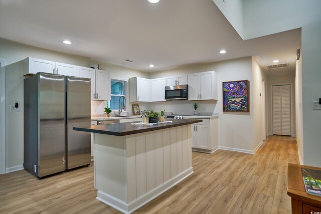 empty room featuring ceiling fan and light hardwood / wood-style floors