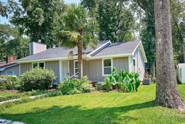 view of front facade with central air condition unit and a front yard