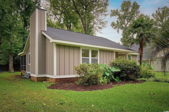 view of side of property with a yard