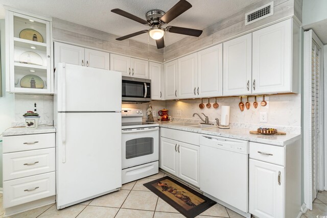 kitchen featuring sink, white appliances, ceiling fan, white cabinetry, and light tile patterned flooring