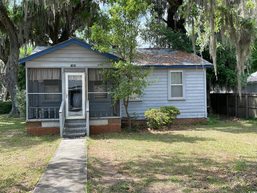 bungalow-style home featuring a front yard