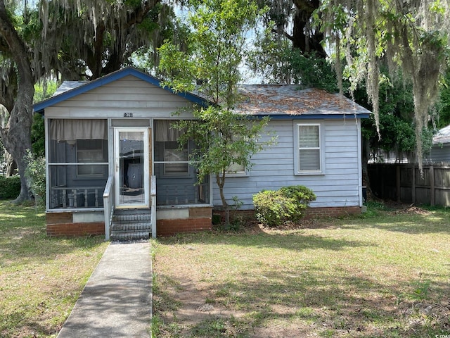 bungalow-style home featuring a front yard