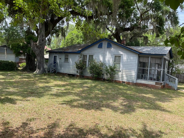 rear view of property featuring a yard