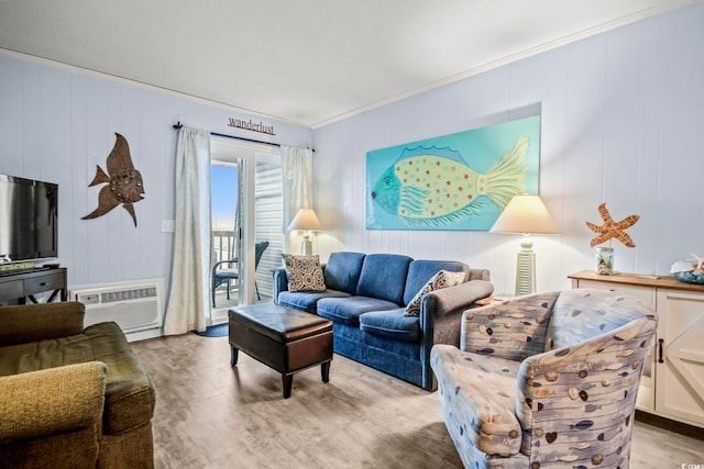 living room featuring hardwood / wood-style flooring, ornamental molding, and a wall unit AC