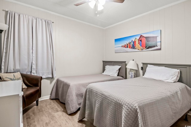 bedroom with ornamental molding, ceiling fan, and hardwood / wood-style flooring