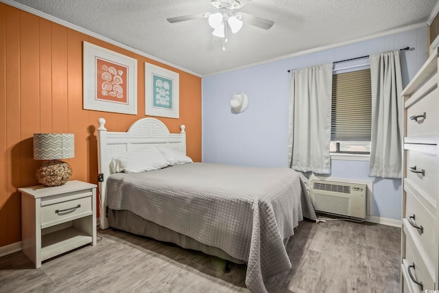 bedroom featuring light hardwood / wood-style flooring, ceiling fan, and a textured ceiling