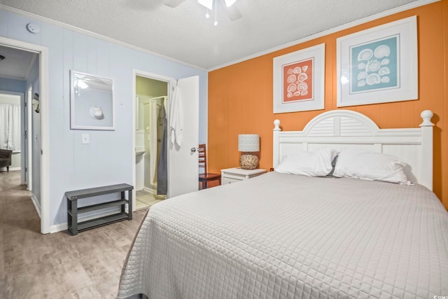 bedroom with ornamental molding, ensuite bath, ceiling fan, and a textured ceiling