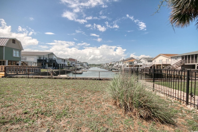 view of yard featuring a boat dock and a water view